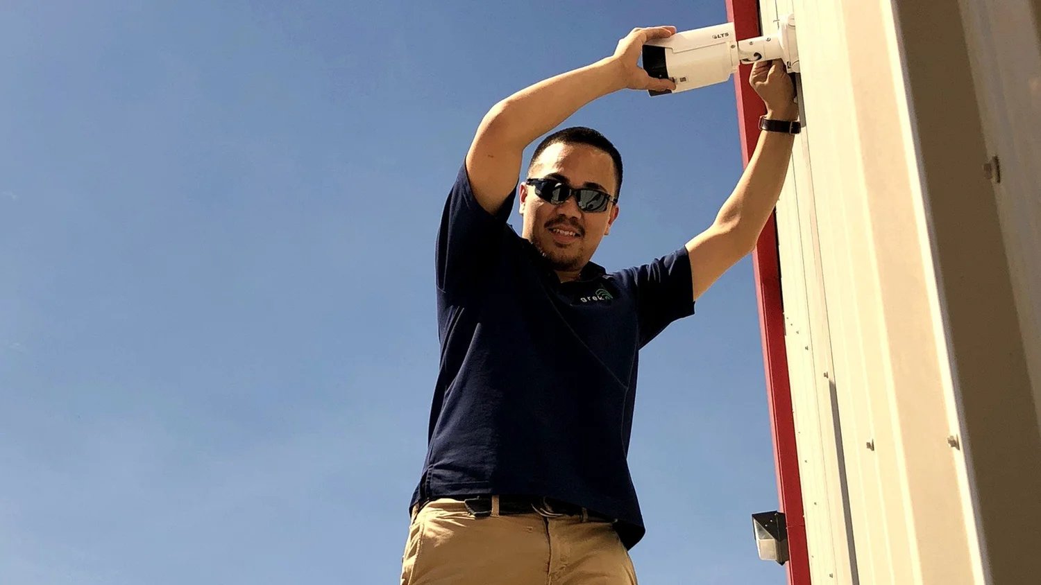 Itenco technician mounting a security camera